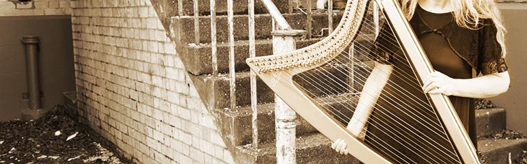 Auckland harp player and singer Robyn Sutherland and her gold electric Camac harp