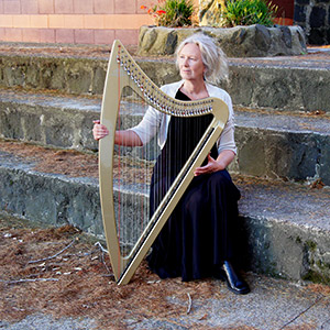 Auckland harp player and singer Robyn Sutherland with her electric gold Camac harp